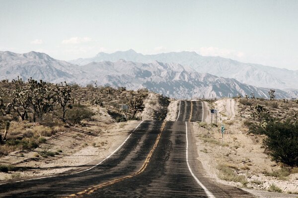 Winding road among sand and mountains