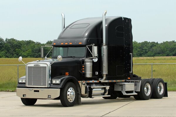 Black truck with chrome pipes