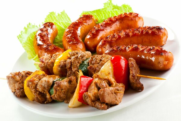 Fried kebabs and sausages on a white background