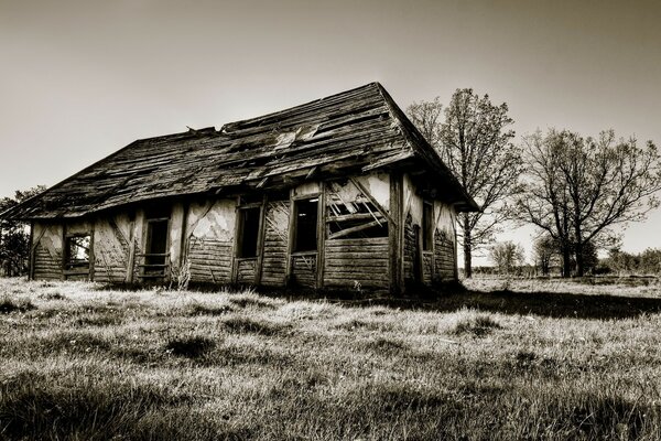 A ruined old house. Sepia. Old man