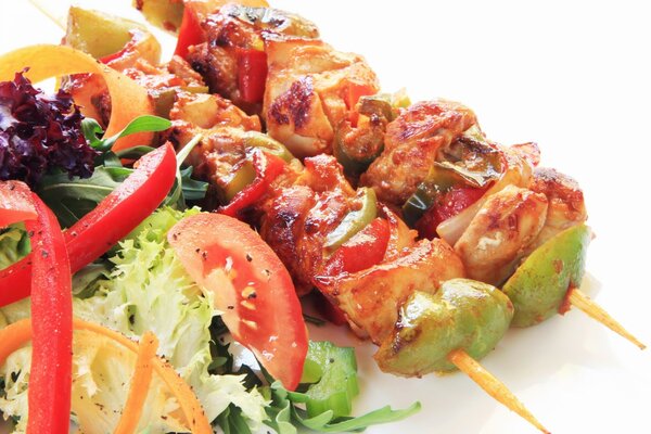 Salad and kebabs on a white background