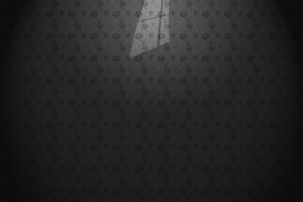 The light from the window falling on the gray wallpaper