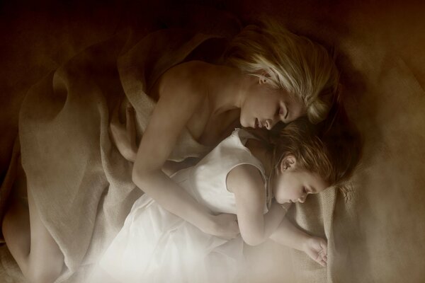 The girl sleeps next to her daughter