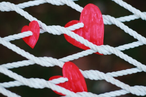 Painted hearts woven with rope