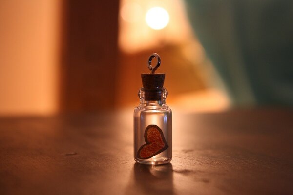 A bottle on the table with a painted heart inside