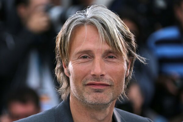 Mads Mikkelsen looks at the camera