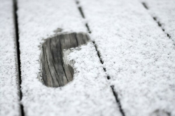 A footprint on a thin blanket of snow