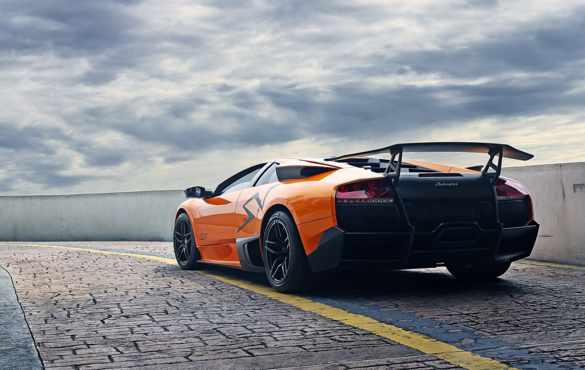 lamborghini murcielago lp670-4 sv orange lamborghini murcielago back paving stones fencing sky cloud