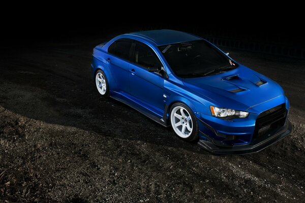 Blue Mitsubishi car tuning on a black background