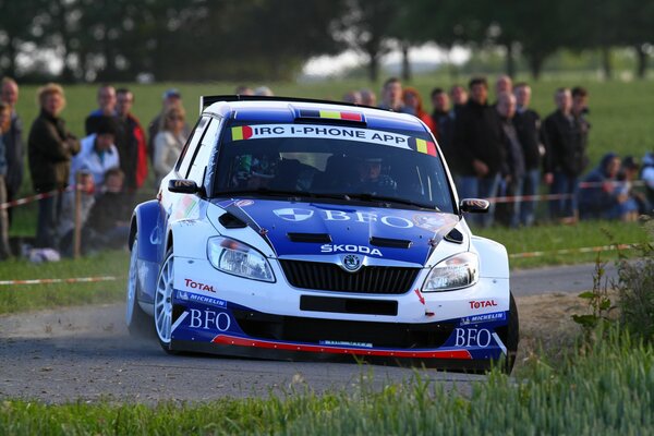 Spectators at the rally watching the movement of Skoda