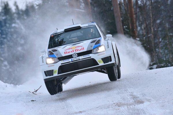 Volkswagen racing car rides on a snowy highway