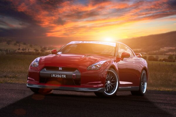 Red Nissan car on the background of sunset in the field