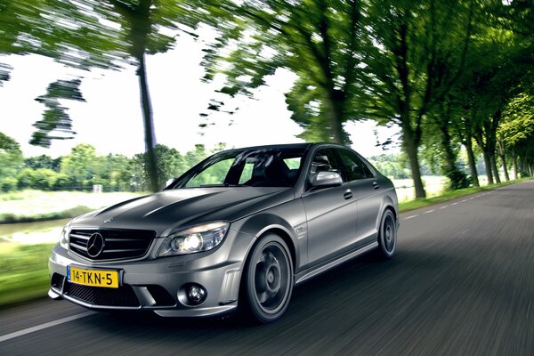 Mercedes sedan on the road in motion mercedes c63 amg