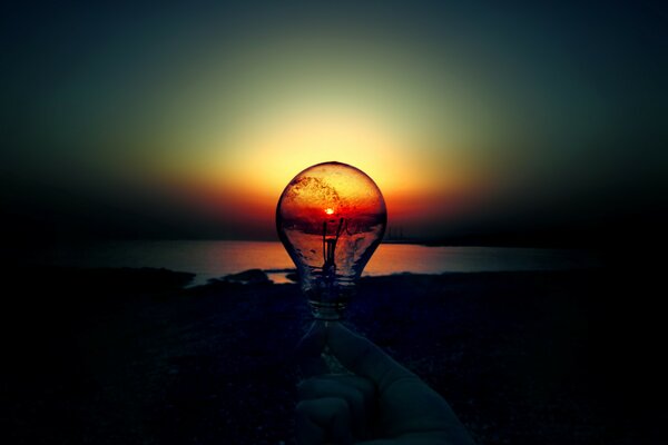 Sunset on the sea in a light bulb