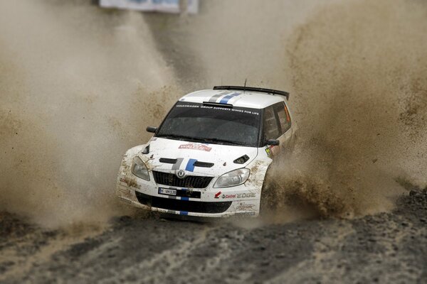 Skoda overcomes a huge puddle of mud at the rally