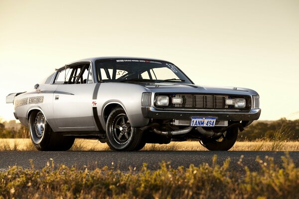 Chrysler Valiant on the road through the fields