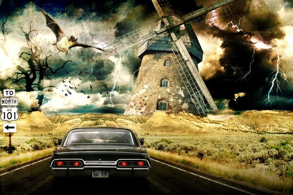 A car on the background of a windmill