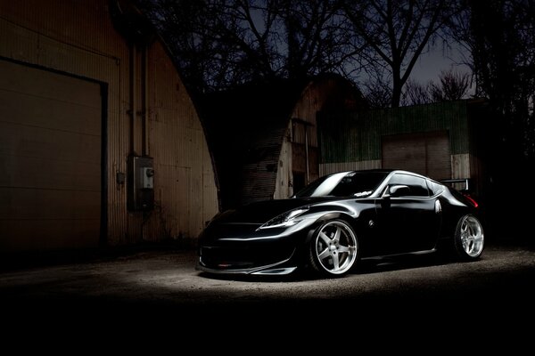 Black sports tuned Nissan in the night