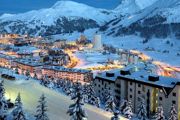 A fabulous winter city and the grandeur of snowy mountains