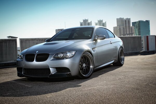 BMW in the parking lot, and high-rise buildings in the distance