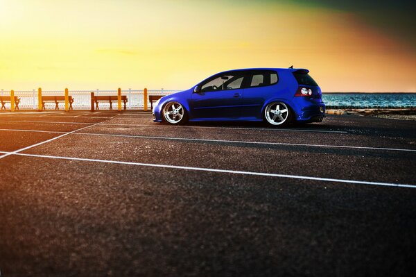 Blue volkswagen golf on the embankment