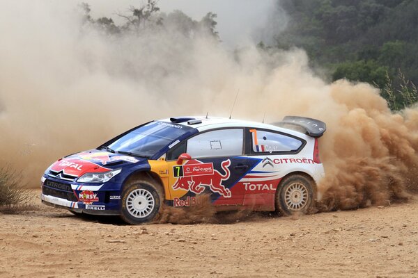 Citroen rides through the sandy desert at the competition