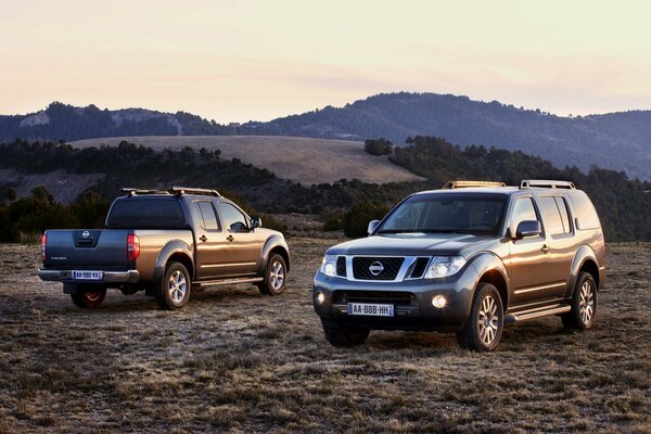 Two cars in the mountains at dawn