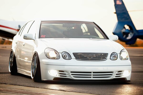 White Lexus on the background of an airplane