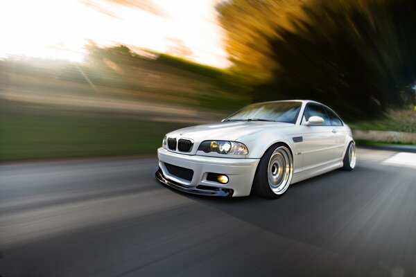 Fast white bmw car driving on the highway