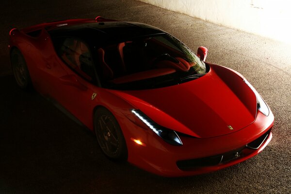 A red Ferrari in the semi-darkness. Top view