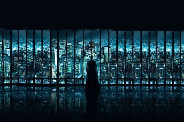 Batman regarde la ville par la fenêtre