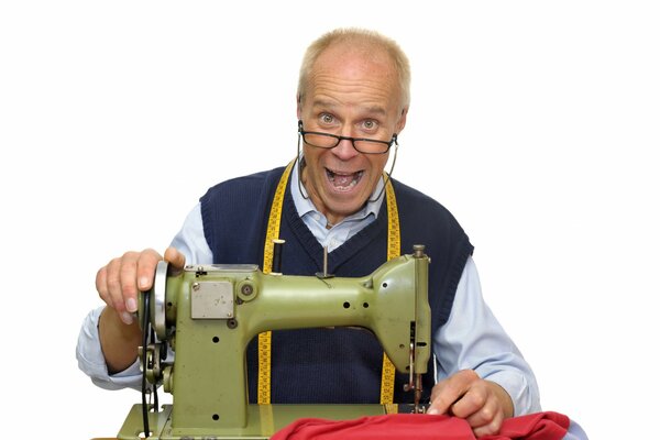 Tailor with glasses at the sewing machine