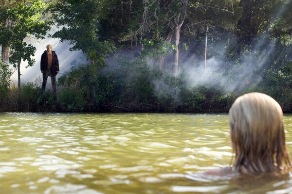 Bathing a young lady in a forest lake