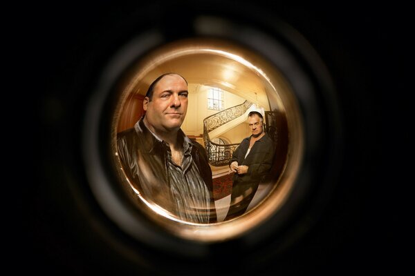 Two men from the series can be seen through the peephole in the door