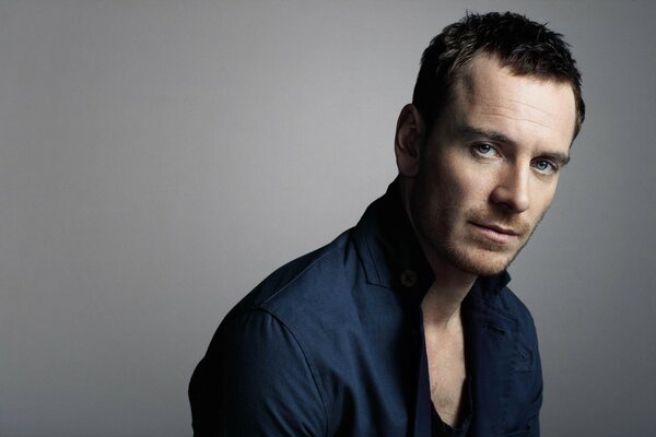 Actor Michael Fassbender on a gray background