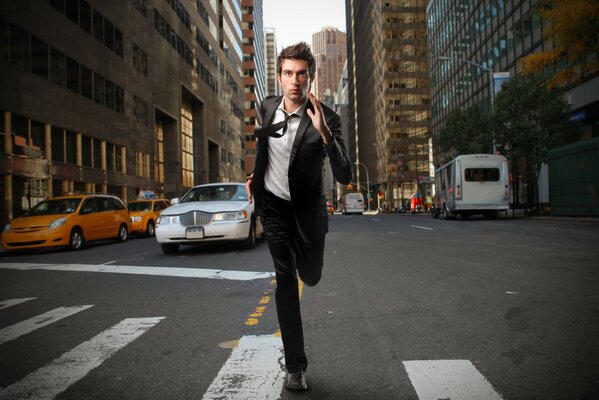 A man running past cars in the city