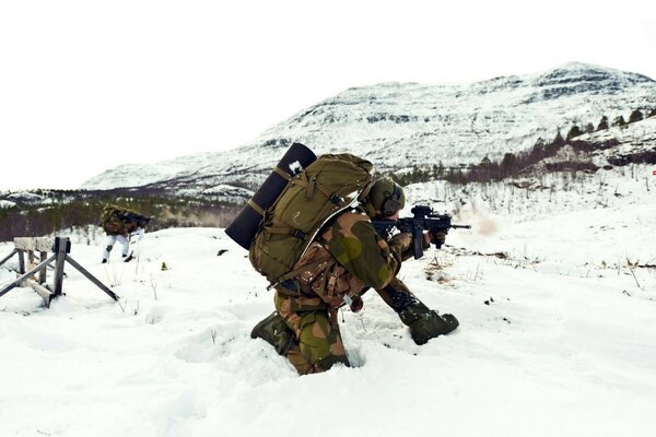 Soldiers with weapons in the winter cold