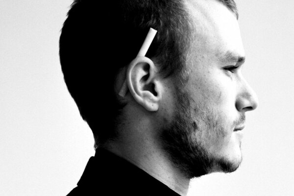 Profile of a man with a cigarette behind his ear