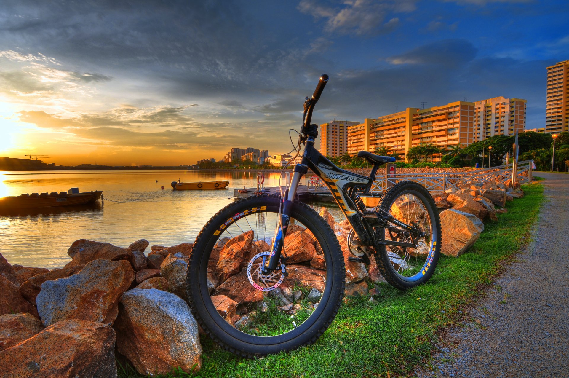 town bike stones river boat sunset