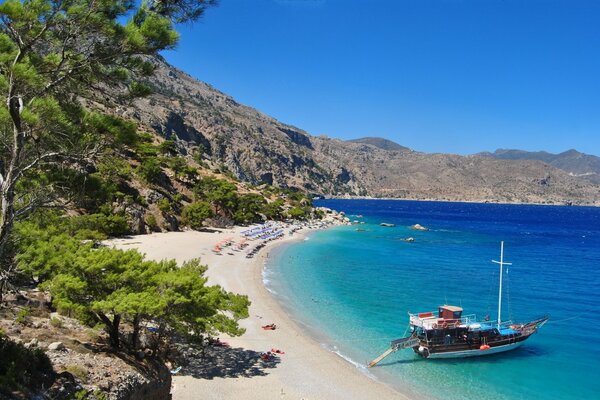 Greek beach and yacht at the shore