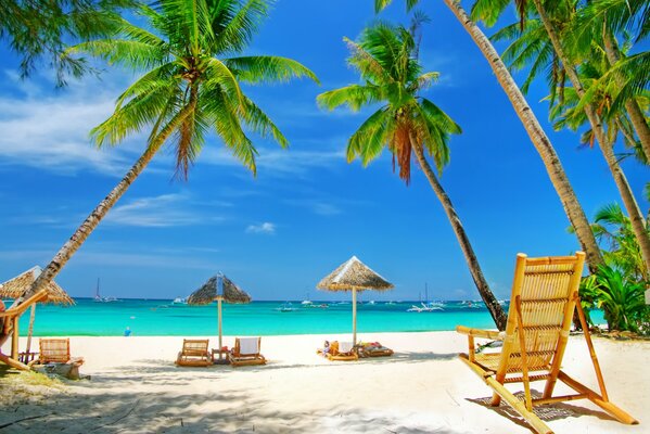 Azure beach with white sand and sun loungers