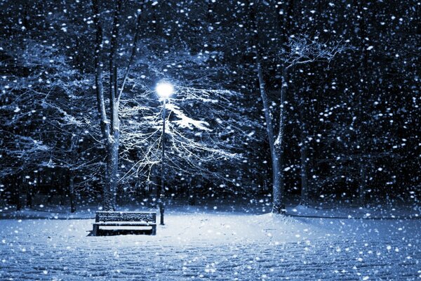 An empty bench on a cold winter evening