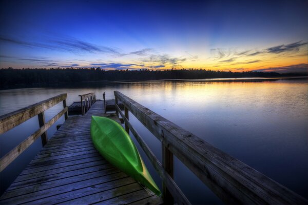 Kayak on the pier near the river water