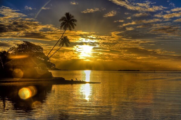 Sunset on the seashore sun glare and bungalows