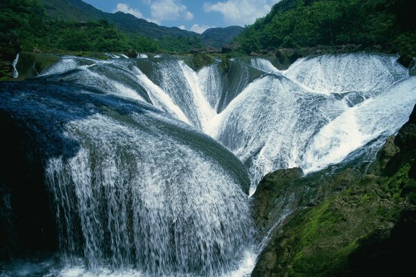 Waterfall landscape with green stones