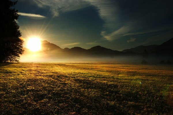 Sunset behind massive mountains