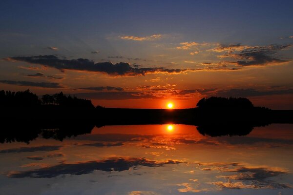 Sunset on the background of a mirror lake