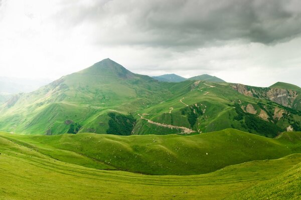 Nature green hills nearby thunderclouds