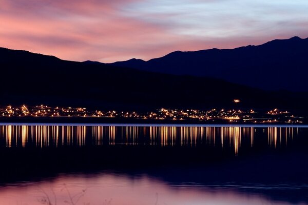 Landscape of the evening city with a pond