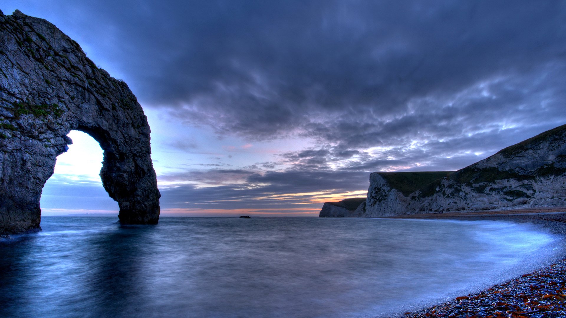 mar bahía rocas inglaterra nubes